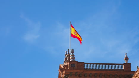 Spanish-flag-waving-on-top-of-one-of-the-towers-of-Plaza-de-España-in-Seville