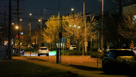 white suv making u-turn under street lighting at night