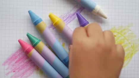 child playing with crayons