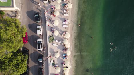 Aerial-topview:-Kotor-beach,-Montenegro,-showing-bustling-seaside-activities