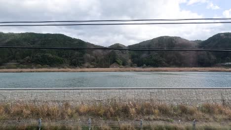 passing by a tranquil lake and hills on a drive