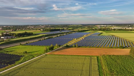 green fields and solar panels under a bright sky in bubesheim germany, aerial view