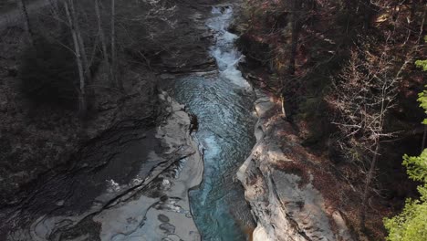 aerial view of a mountain river with beautiful waterfall in the afternoon sunlight