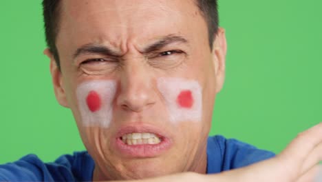 man with japanese national flag upset with a referee