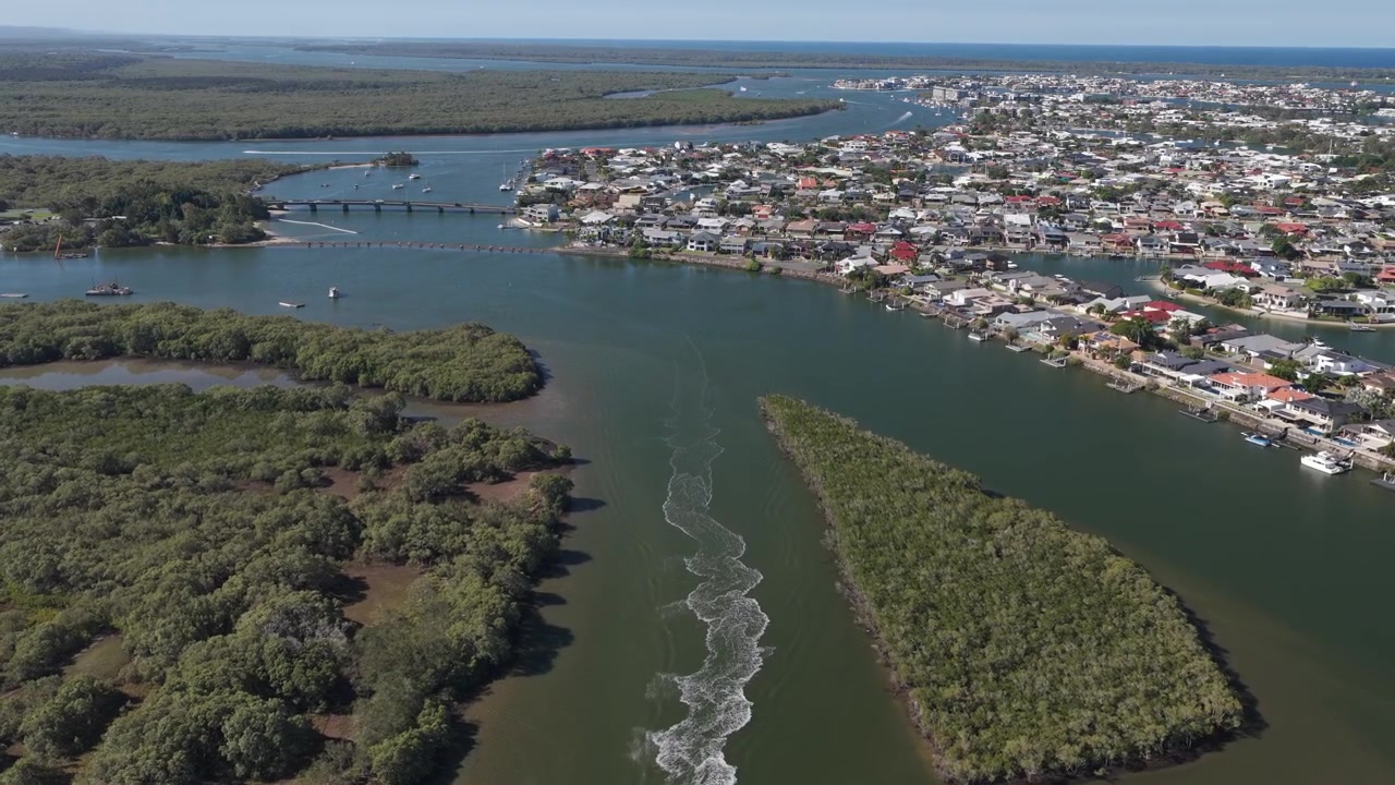 Moto d'acqua che crea una scia a Coombabah Creek a Paradise Point, Gold Coast, QLD, Australia. - Ripresa aerea.