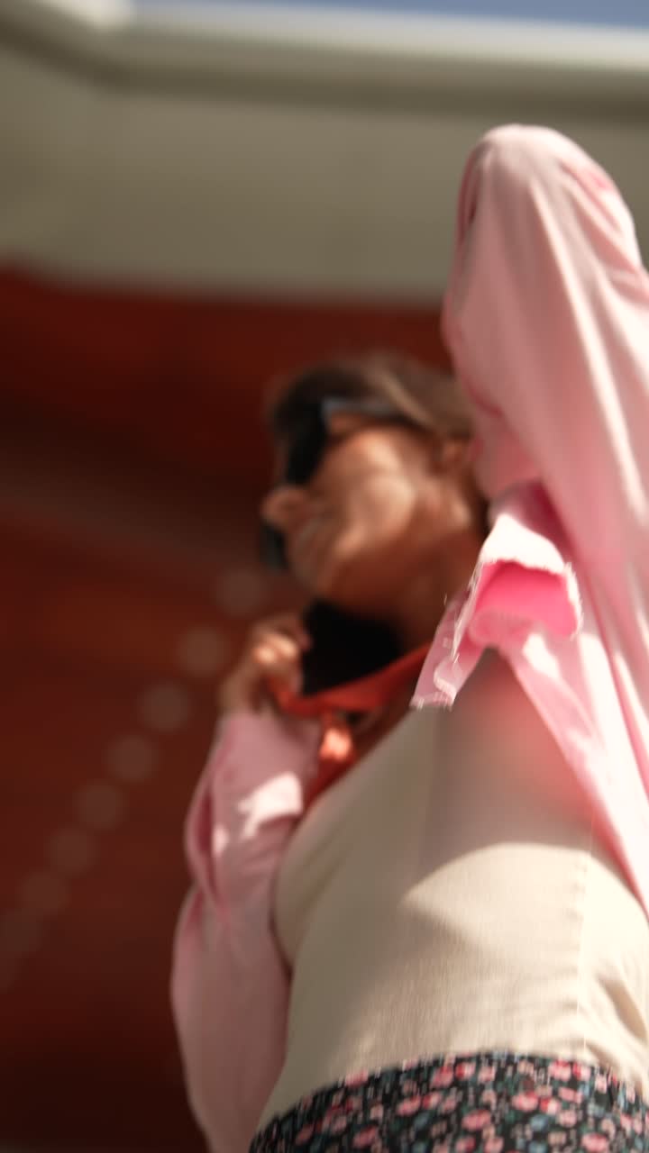 분홍색 셔츠와 꽃색 치마를 입은 여자