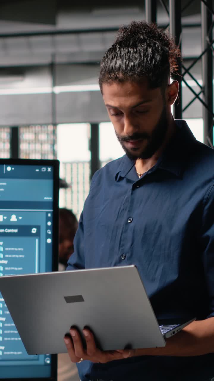 Vertical Video Male developer evaluating architectural 3D models and plans
