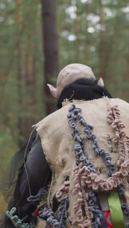 animator in monster costume runs away in forest, children's camp