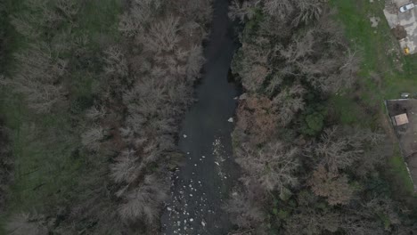 Top down view of a water treatment plant next to a river in amelie les bains, france, showcasing its structures and surrounding environment