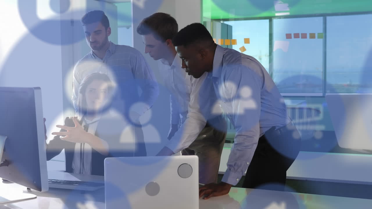 Animation of digital icons over business people using computers