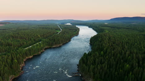 schöne luftbilder eines flusses, der durch die weite, offene landschaft im norden schwedens fließt.