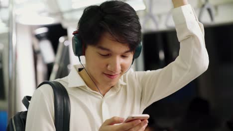 Businessman-using-mobile-phone-on-public-train