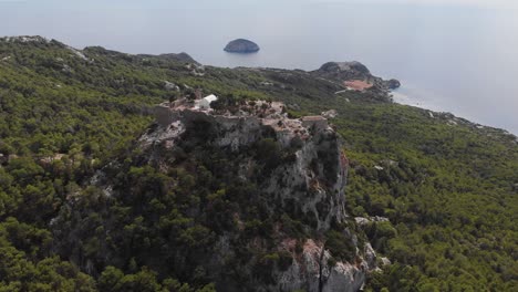 Aerial:-Flying-backwards-above-ancient-Castle-of-Monolithos,-Rhodes-Island