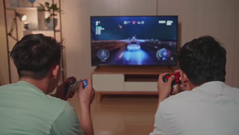 two friends playing video games at home