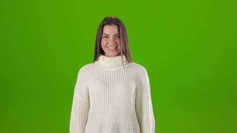 portrait of young woman smiling on camera in studio