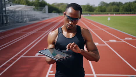 athlete using smart technology on a running track
