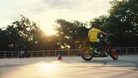 shooting professional motorcyclists in a motorcycle school. the motorcyclist's house is on the range in sunny weather