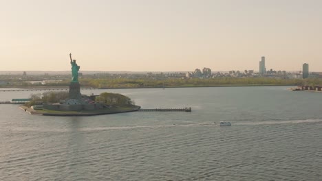 statue of liberty under hazy sky due to climate change and air pollution, new york, usa