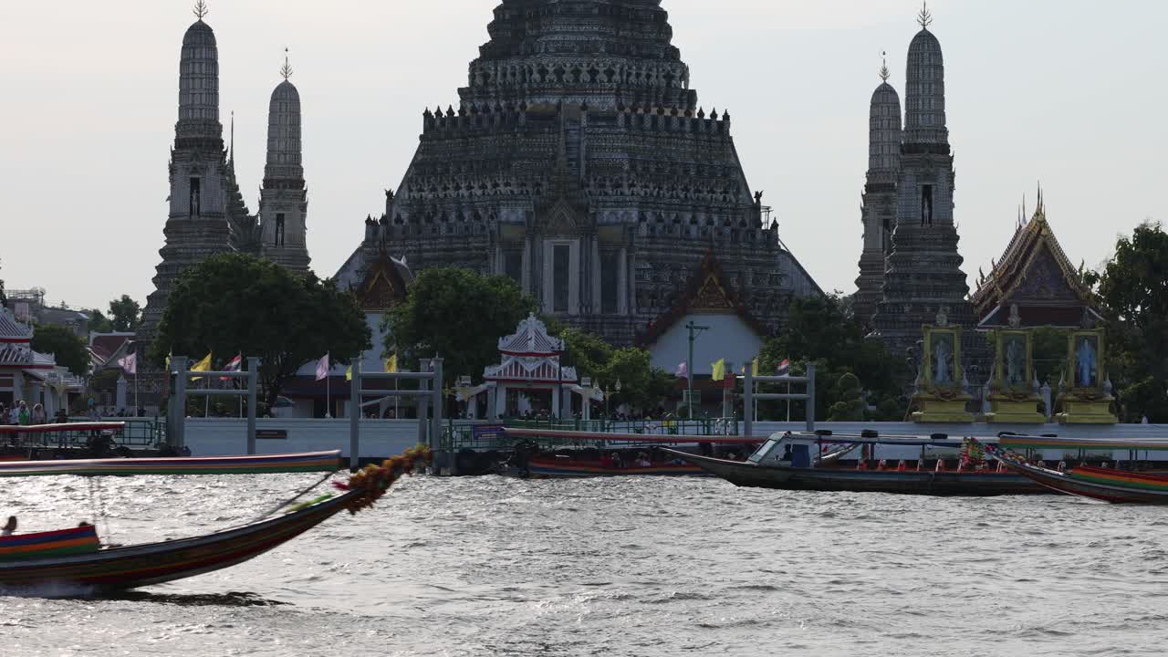 Speedboats racing by a traditional Thai temple