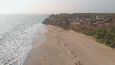 backward moving aerial over empty and vacant beach with beautiful cliffs during sunset, due to travel bans for containment of covid-19