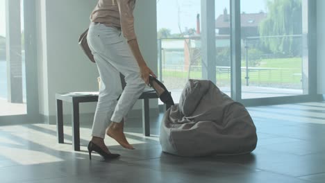 Tired-woman-undressing-shooes-after-hard-day.-Stressed-woman-undressing-footwear