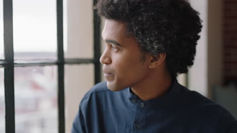 portrait-young-businessman-drinking-coffee-at-home-entrepreneur-enjoying-calm-relaxed-morning-looking-out-window-thinking-contemplative-trendy-afro-hairstyle