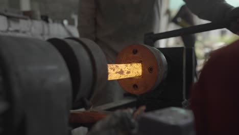 ironworkers forging metal, process of hot spinning iron ore on a lathe