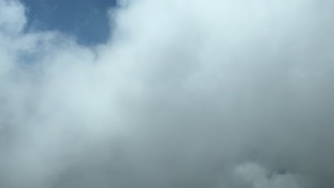 unique pilot’s perspective during a right turn over mallorca’s island, flying trough some fluffy clouds