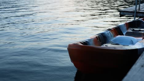 orange kayak gently rocking on serene lake