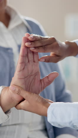 doctor examining an elderly patient's hand