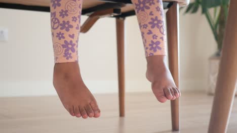 child sitting at a table with patterned tights