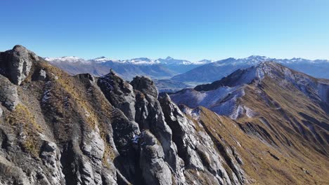 drone flyover rocky mountain ridge reveal high peaks