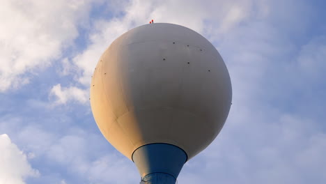 closeup timelapse of water tower with clouds