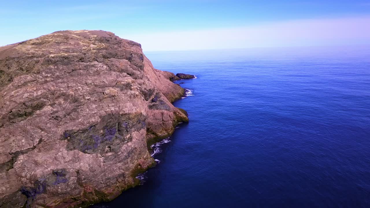 Panning along a beautiful coastal cliff, overlooking into the atlantic ocean