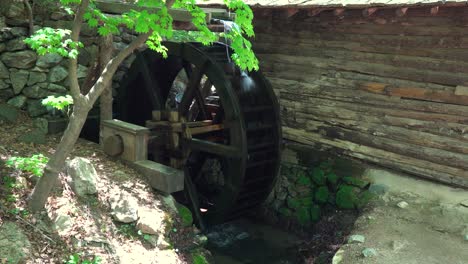 big water wheel as a part of watermill in a zen garden at a korean folk village -full shot