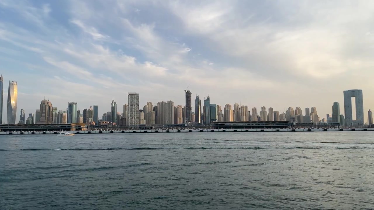 Pan right shot of Jumeirah Beach Residence skyline at sunset, Dubai