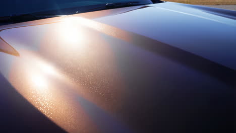 Close-up of an iridescent car hood with shimmering paint