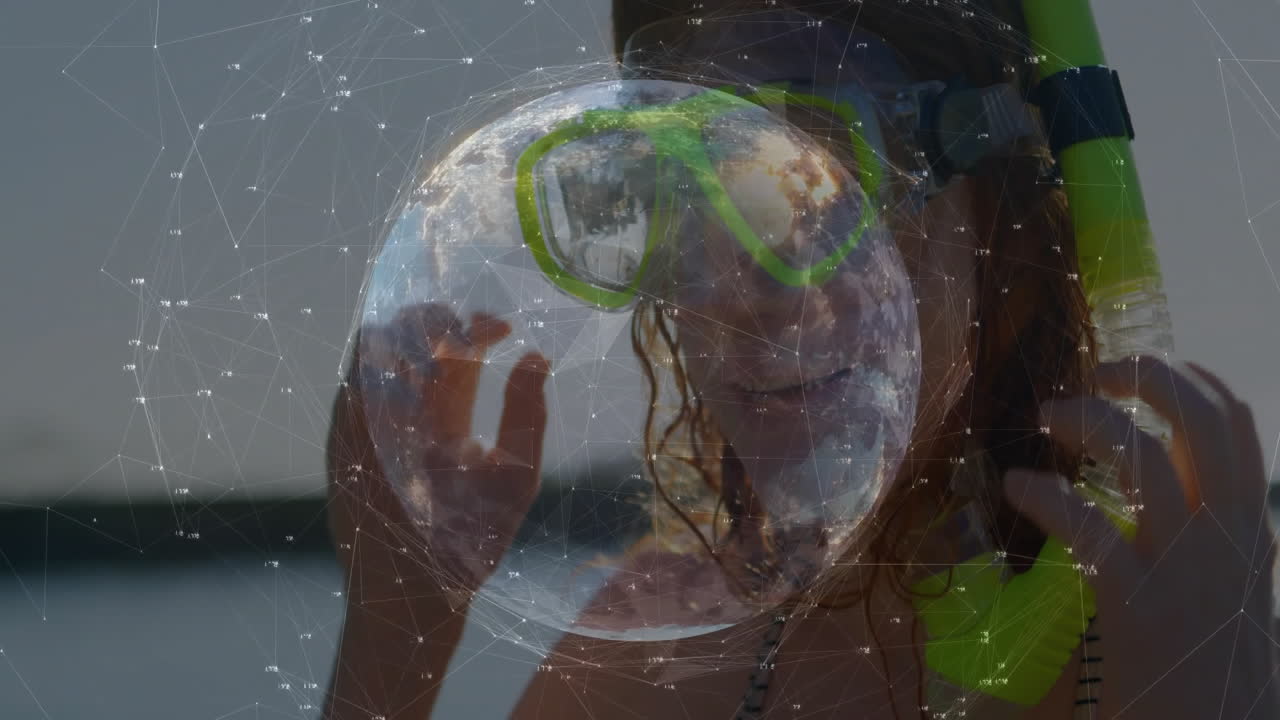 Adjusting snorkel mask, woman with digital globe and network animation overlay
