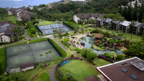 aerial view of resort amenities: pool, tennis courts, and condos on kauai