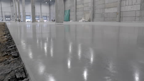 newly poured concrete floor in a warehouse or industrial building under construction