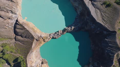 aerial top down shot of the volcanic crater in kelimutu volcano at flores island, indonesia