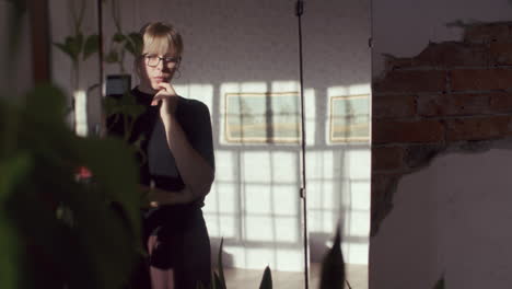 woman in a room with sunlight and art
