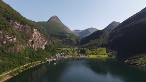 Aerial-Pullback-Reveals-Small-Norwegian-Village-in-Geiranger-Fjord,-Norway