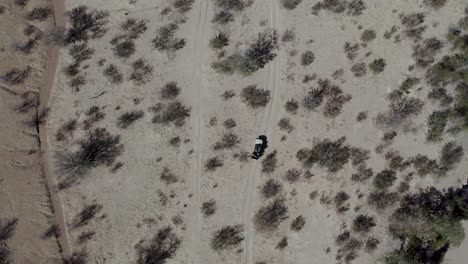 Car-driving-through-Namibia-landscape-during-safari,-Africa