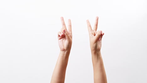 Hand-showing-two-thumbs-up-scissors-victory-chroma-key-isolated-on-a-white-studio-background-with-copy-space-for-place-a-text-for-advertisement