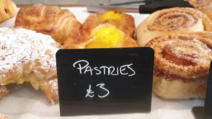 Small blackboard sign for freshly baked pastries and cakes in local cafe and coffee shop