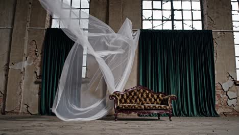 vintage sofa in an abandoned industrial building