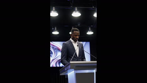 man giving a speech from a podium