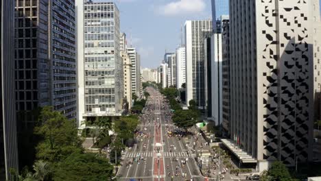 beautiful aerial drone dolly out shot of the famous paulista avenue in the center of são paulo with giant skyscrapers surrounding a 2