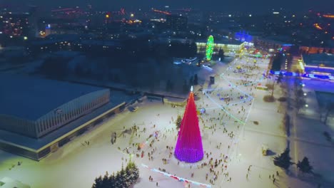 christmas tree with bright neon lights at winter fair aerial